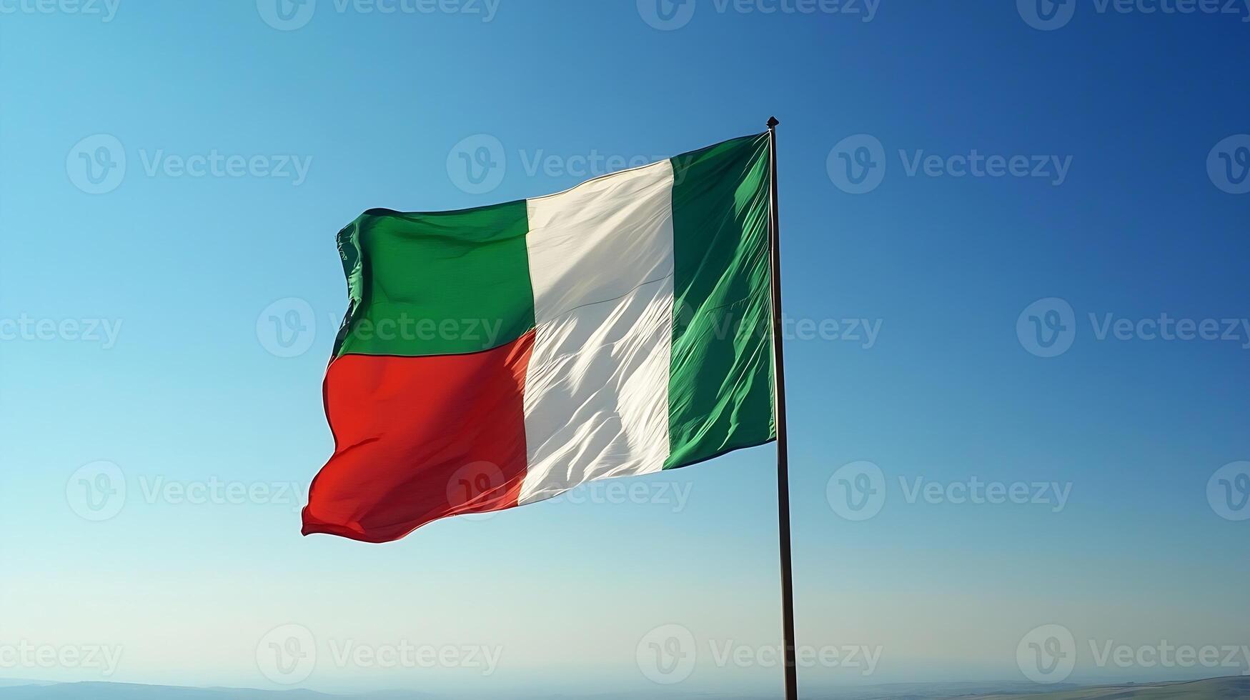 Vibrant and Iconic Italian National Flag Waving Gracefully Against a Clear Blue Sky photo