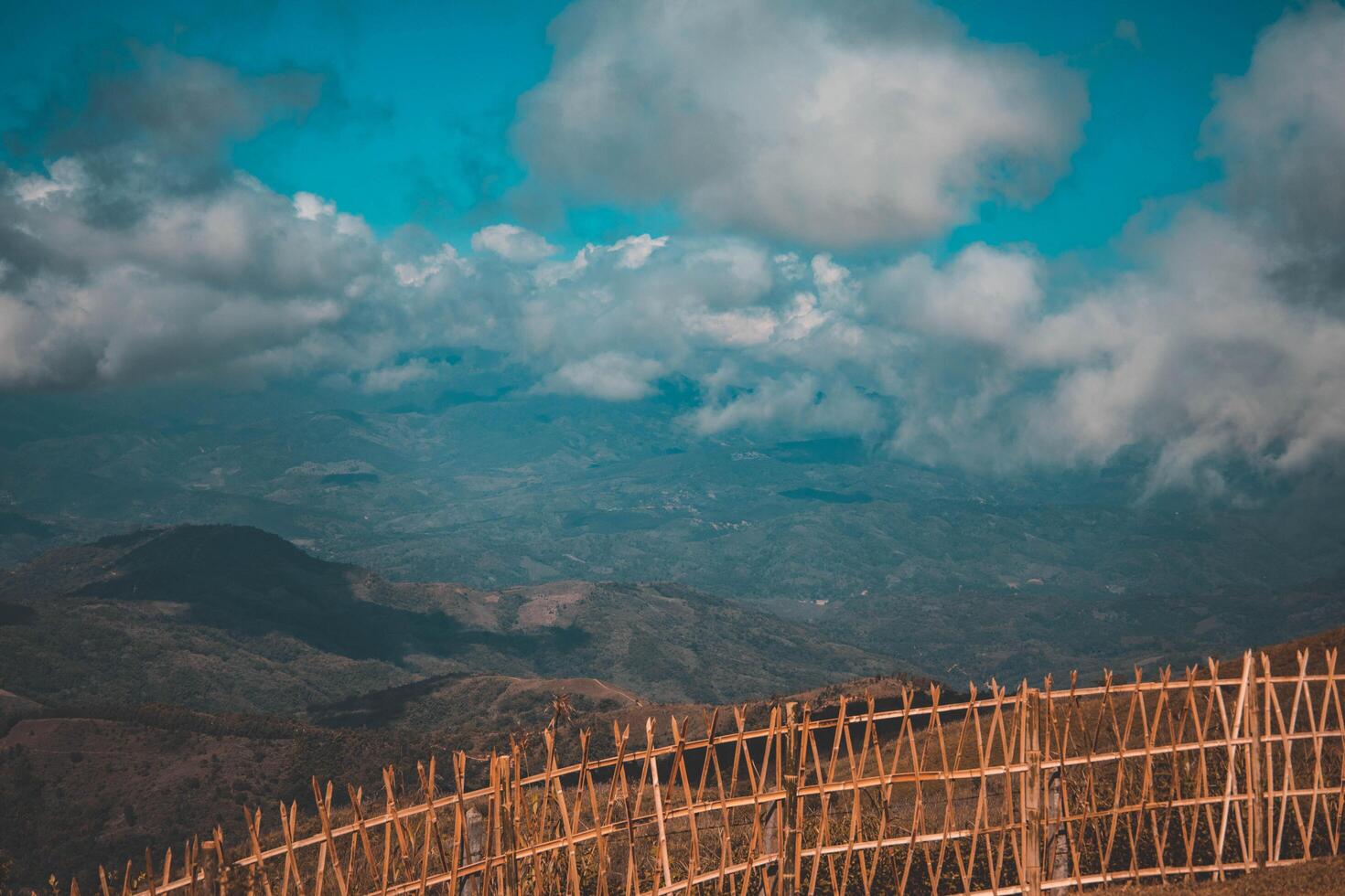 Bamboo fence with mountains. photo