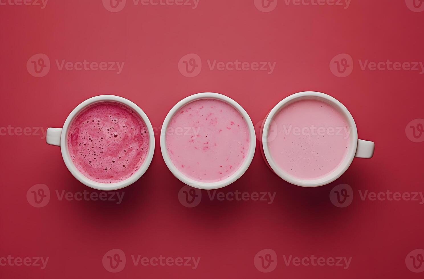 Three mugs of pink drinks showcase varying shades photo
