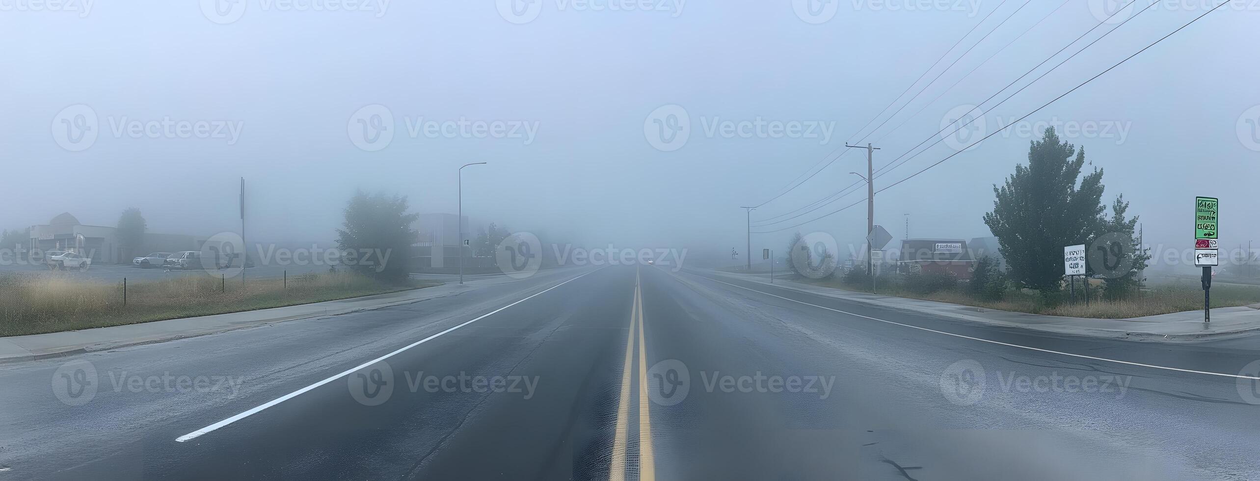Foggy Road Scene With Distant Buildings And Vehicles photo