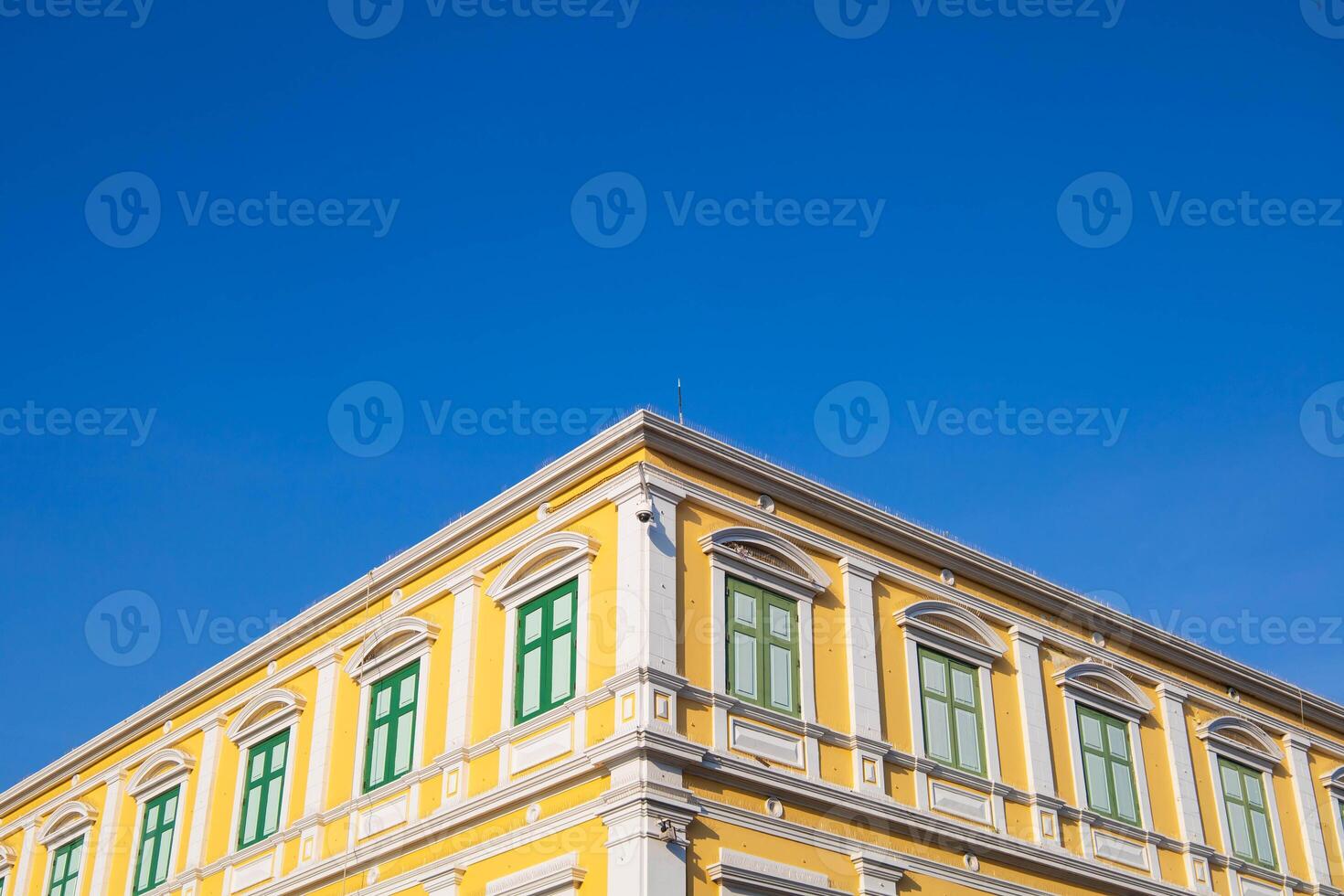 Old brick building with windows and facade under the clear sky, Bangkok, Thailand. photo