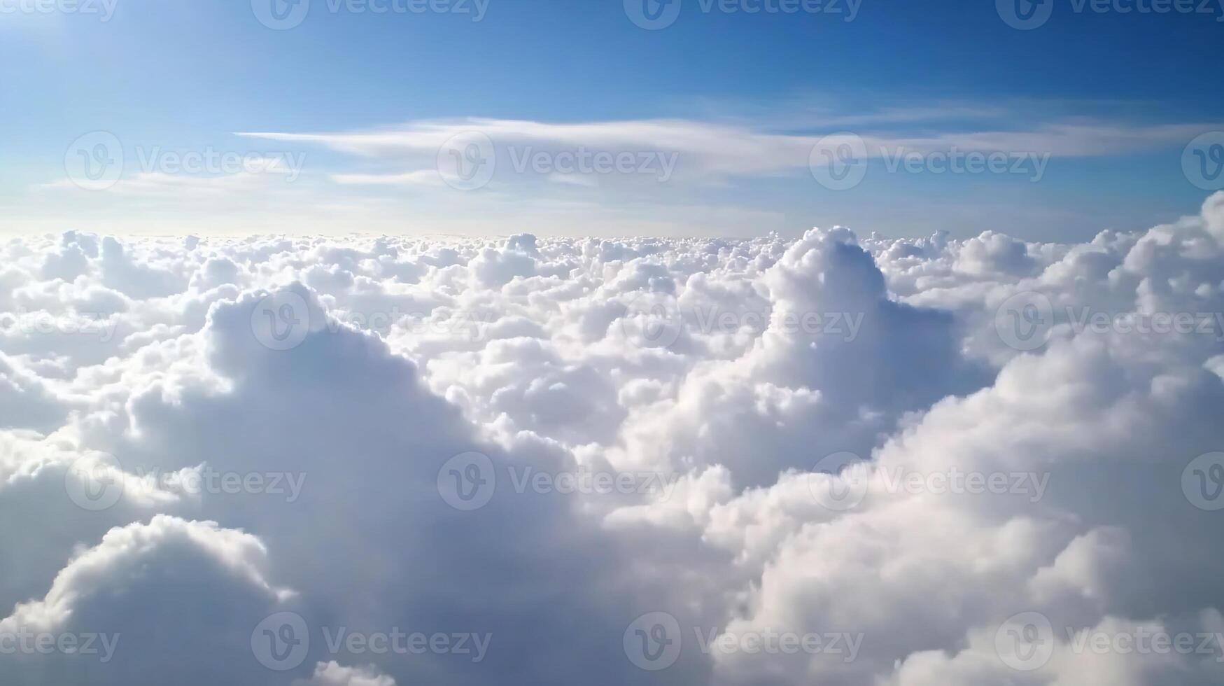 Awe Inspiring View of Fluffy White Clouds in Sunny Blue Sky Captured From Above in Aerial Photo