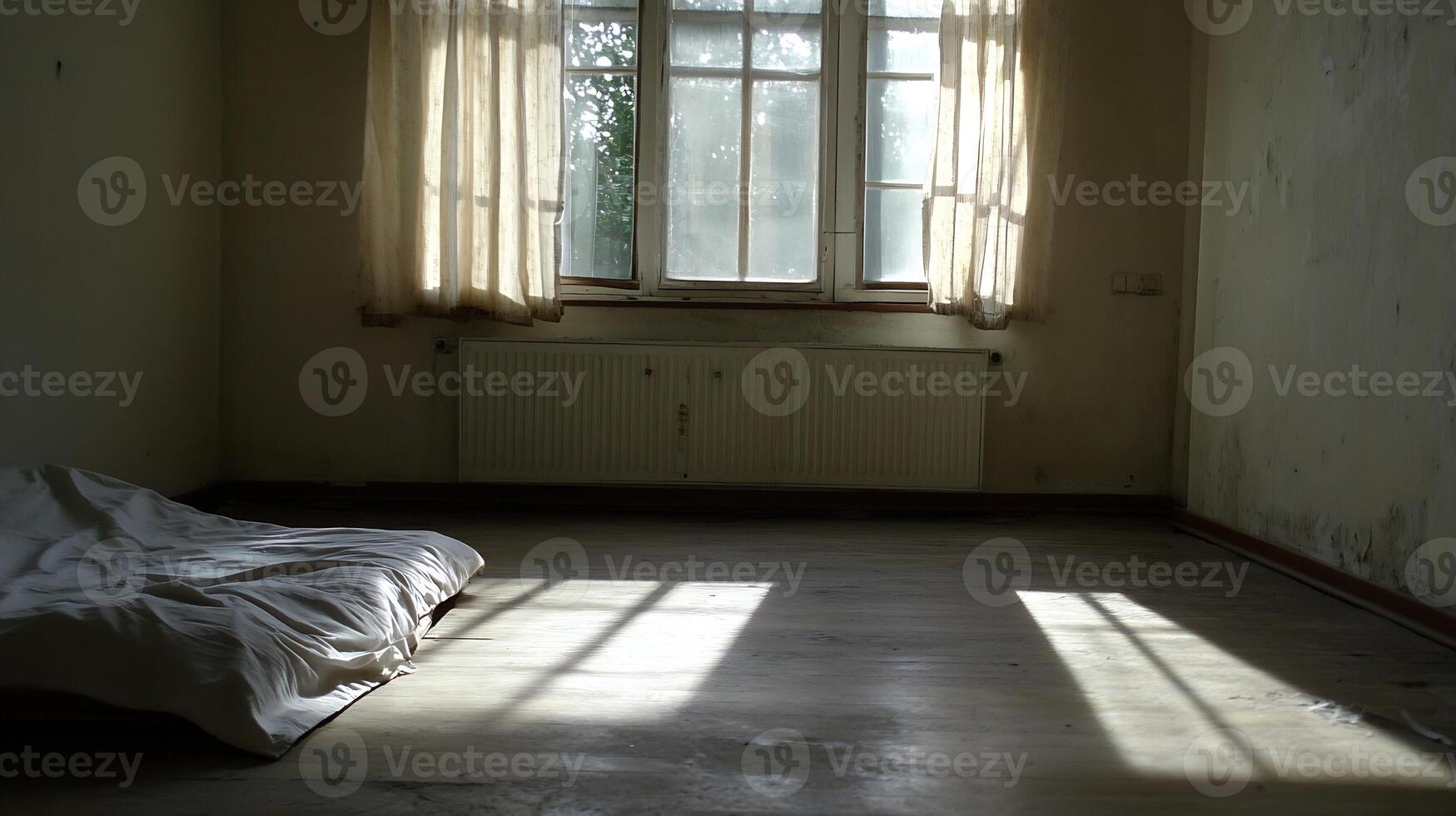 Abandoned Room with Bare Floor and Sunlight Through Curtains photo