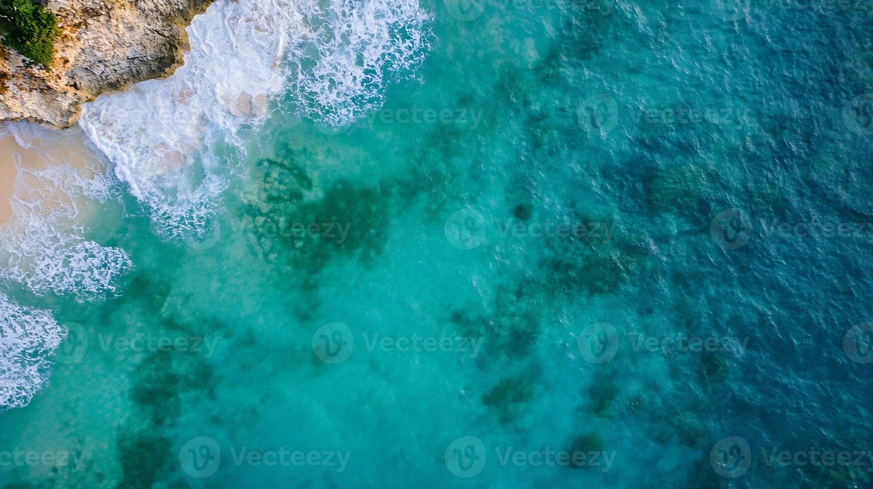 Aerial View of Pristine Turquoise Waves and Rugged Rocky Shoreline photo