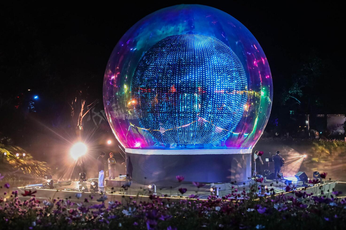 Glowing disco ball with vibrant lights and futuristic design in a public park. Chiang Rai, Thailand. photo