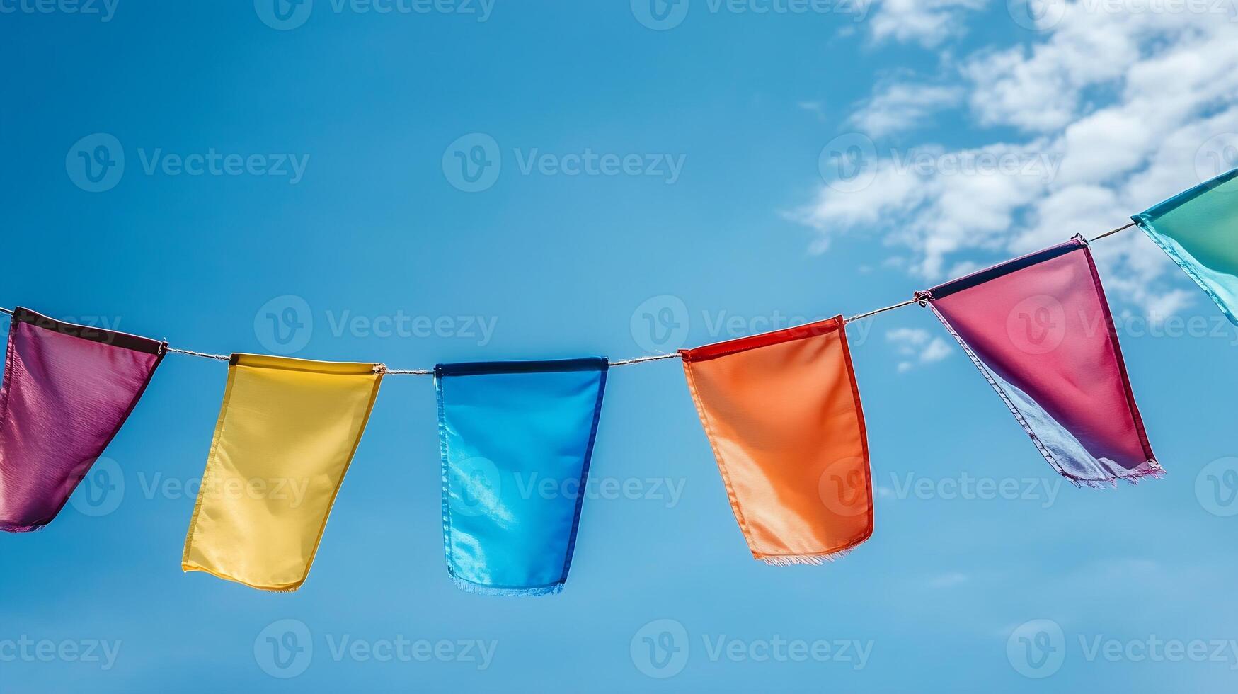 Colorful Festive Pennant Flags Against a Clear Blue Sky photo
