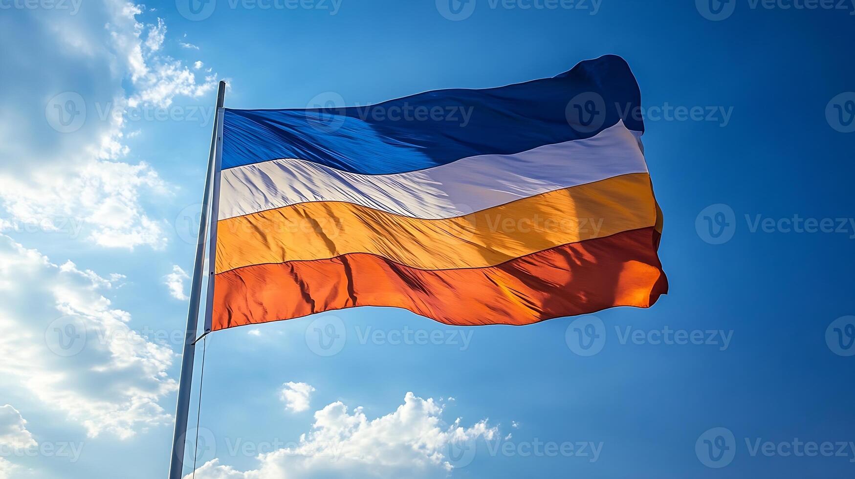 Multicolored Striped Flag Waving Against Clear Blue Sky Symbolizing Unity and Diversity photo