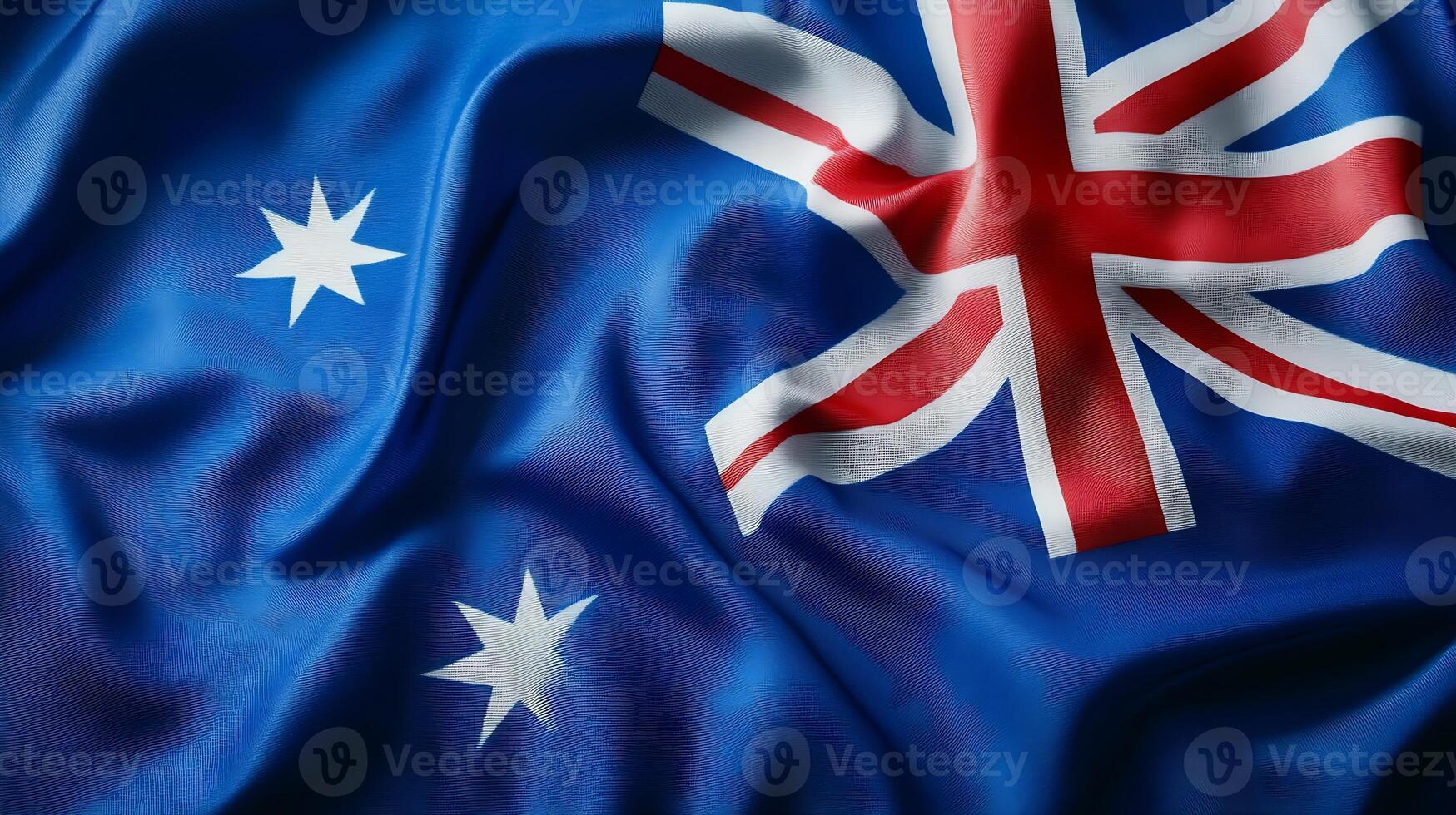 Australian National Flag Waving in the Wind Against Blue Sky photo