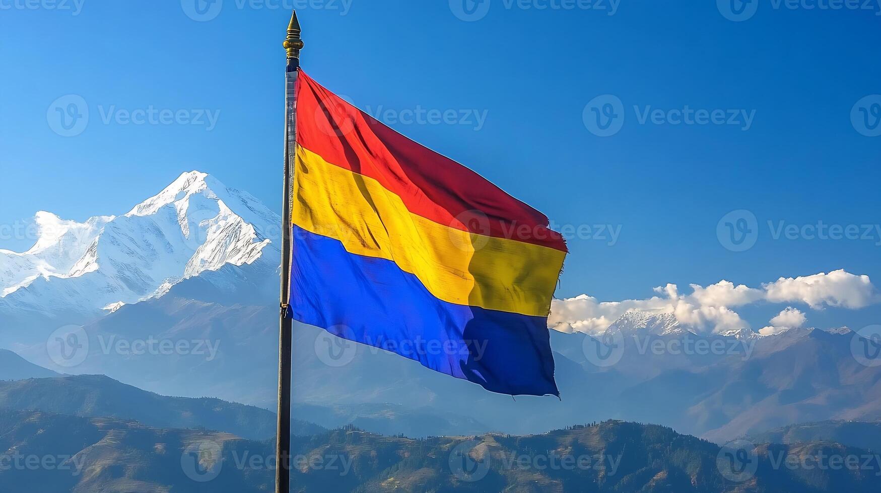 Vibrant Mountain Landscape with Colorful Flag and Snowcapped Peaks in Clear Blue Sky photo
