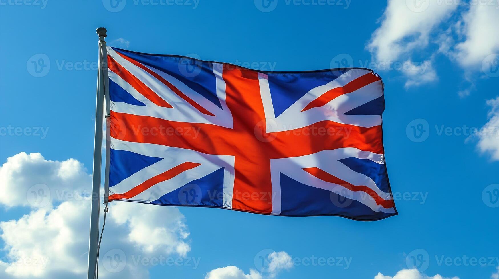 British Union Jack Flag Waving Against a Bright Blue Sky photo