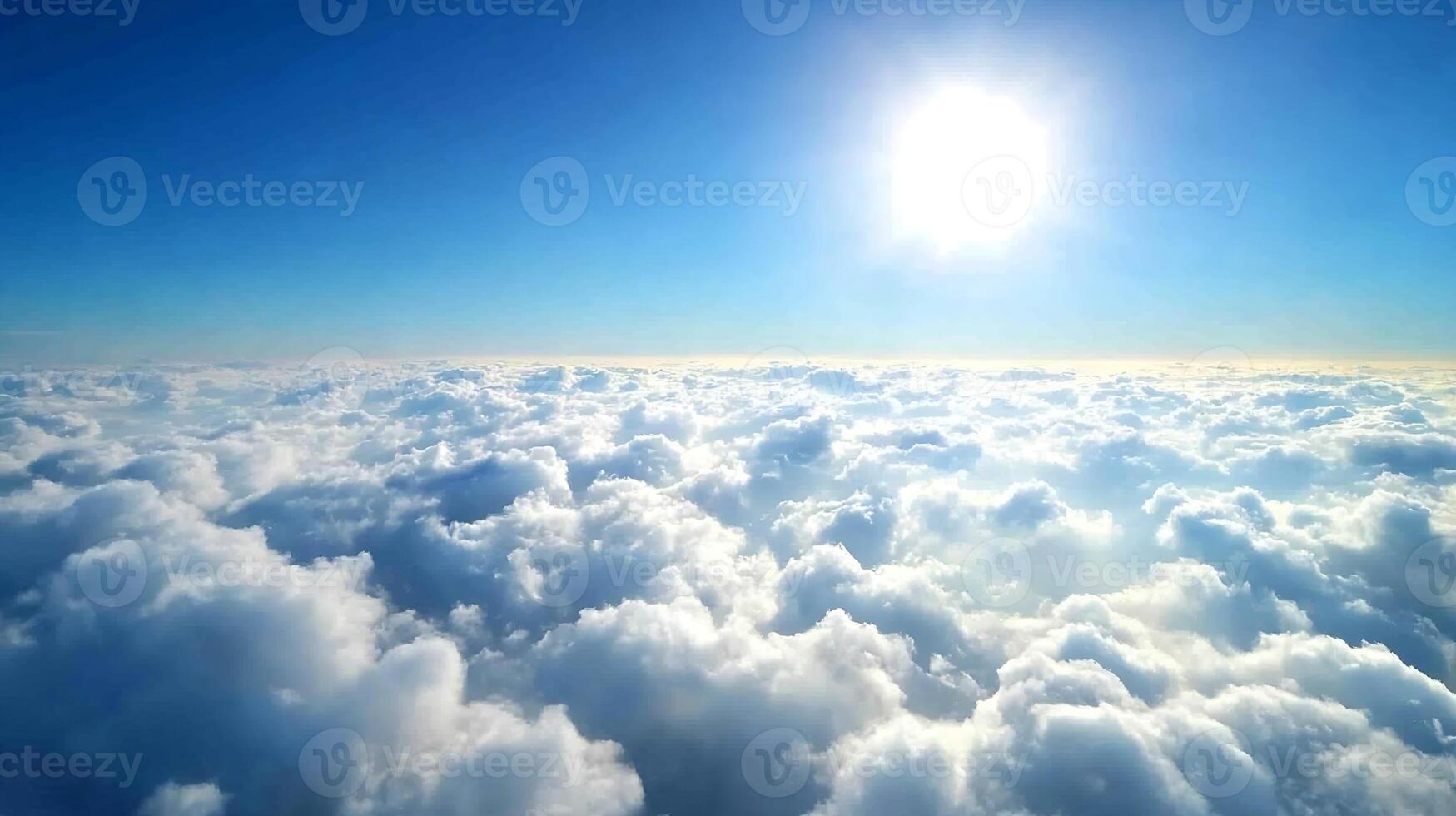 Breathtaking Aerial View of Fluffy Clouds Below Clear Blue Sky and Radiant Sunshine photo