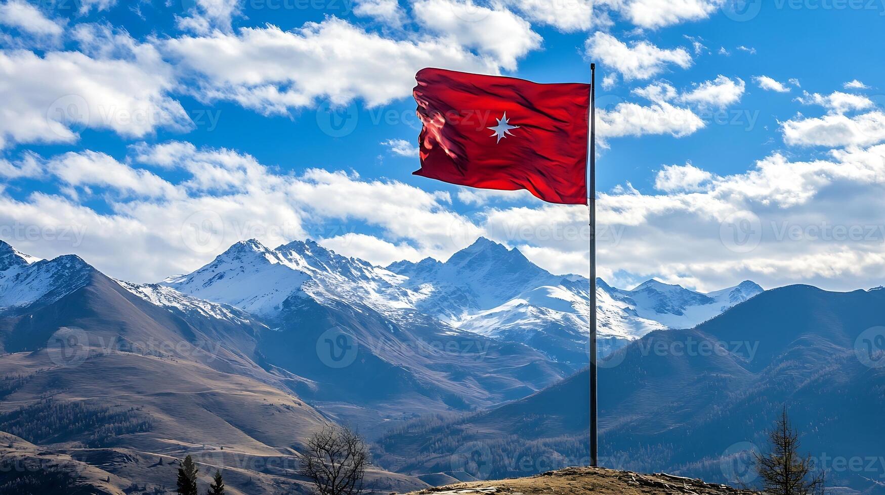 Dramatic Red Flag Flying Against Snowcapped Mountain Landscape photo