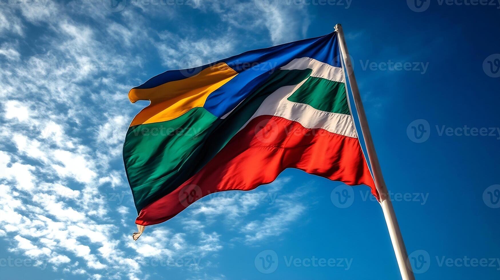 Colorful National Flag Waving Against a Clear Blue Sky on Sunny Day photo