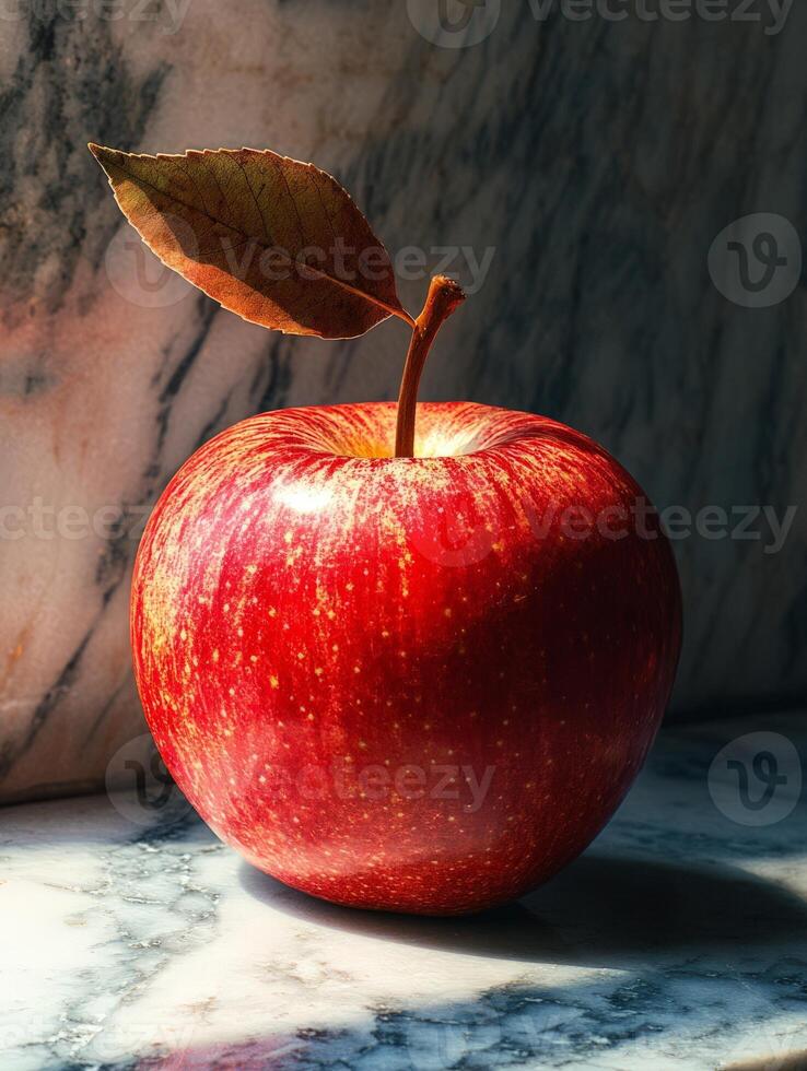 A red apple sitting on a marble counter photo