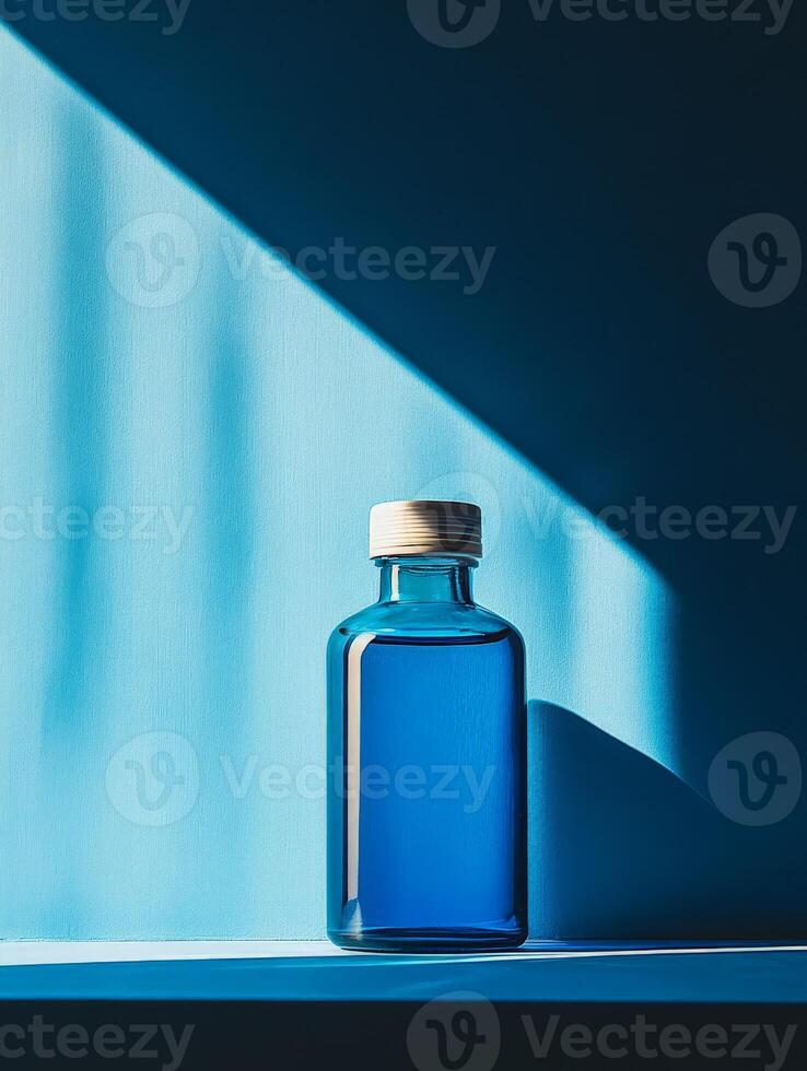 A blue glass bottle sitting on a shelf photo