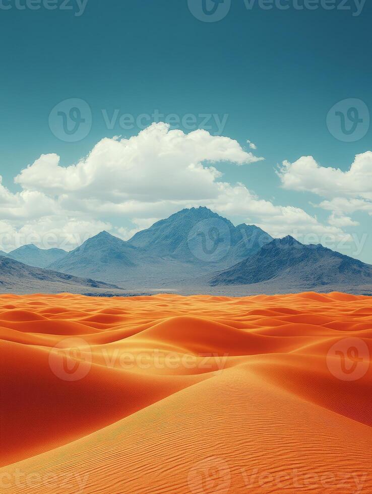 A vast desert landscape with rolling orange sand dunes and distant mountains under a blue sky. photo