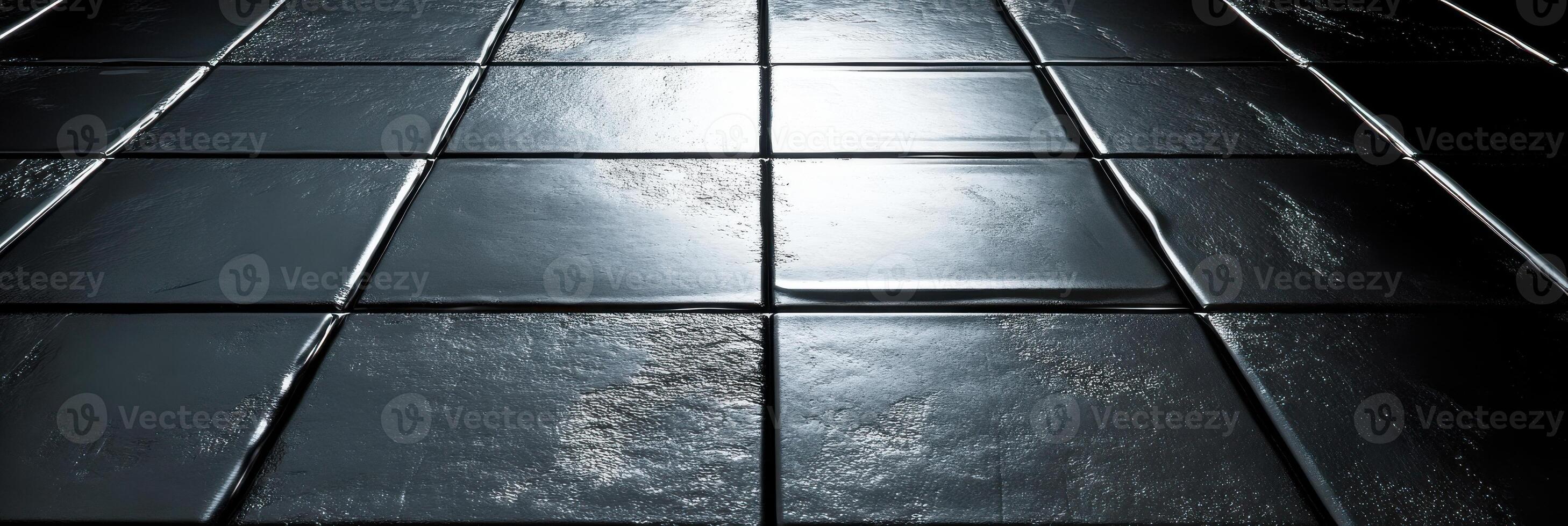 Shiny black square floor tiles with reflective surface and subtle light photo