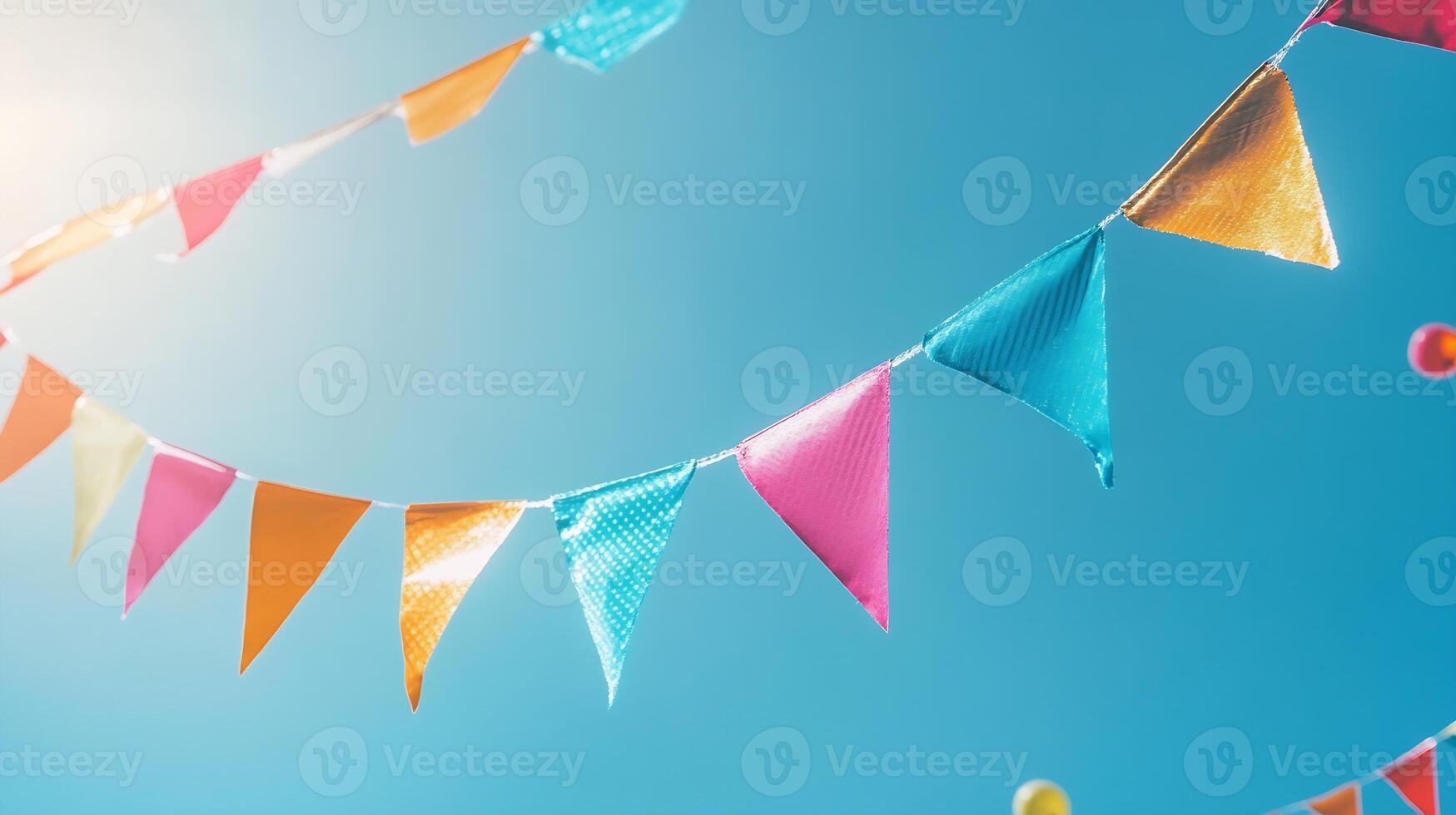 Colorful festival party bunting flags against a clear blue sky celebrating outdoor events and festivities photo