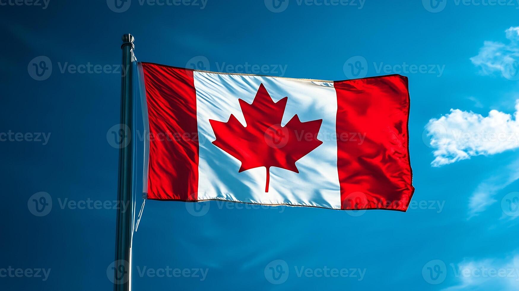 Canadian National Flag Waving in Bright Blue Sky with Vibrant Red Maple Leaf Design photo
