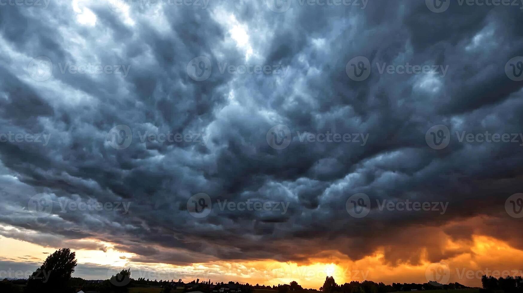 Dramatic Stormy Sky at Sunset with Dark Clouds and Vibrant Orange Horizon photo