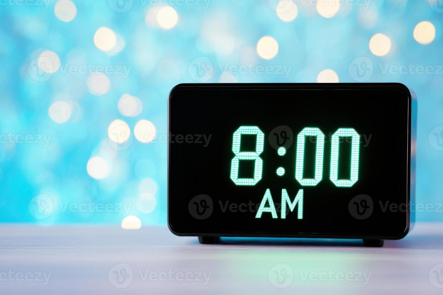 Black digital alarm clock displaying 800 AM against a futuristic metallic background with soft blue neon light photo