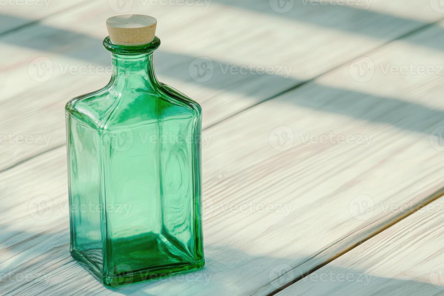 Decorative green glass bottle on rustic wooden table with soft shadows creating a tranquil atmosphere photo