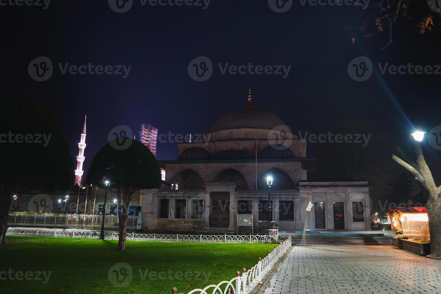 Nighttime View of Ottoman Style Mosque with Illuminated Minaret photo