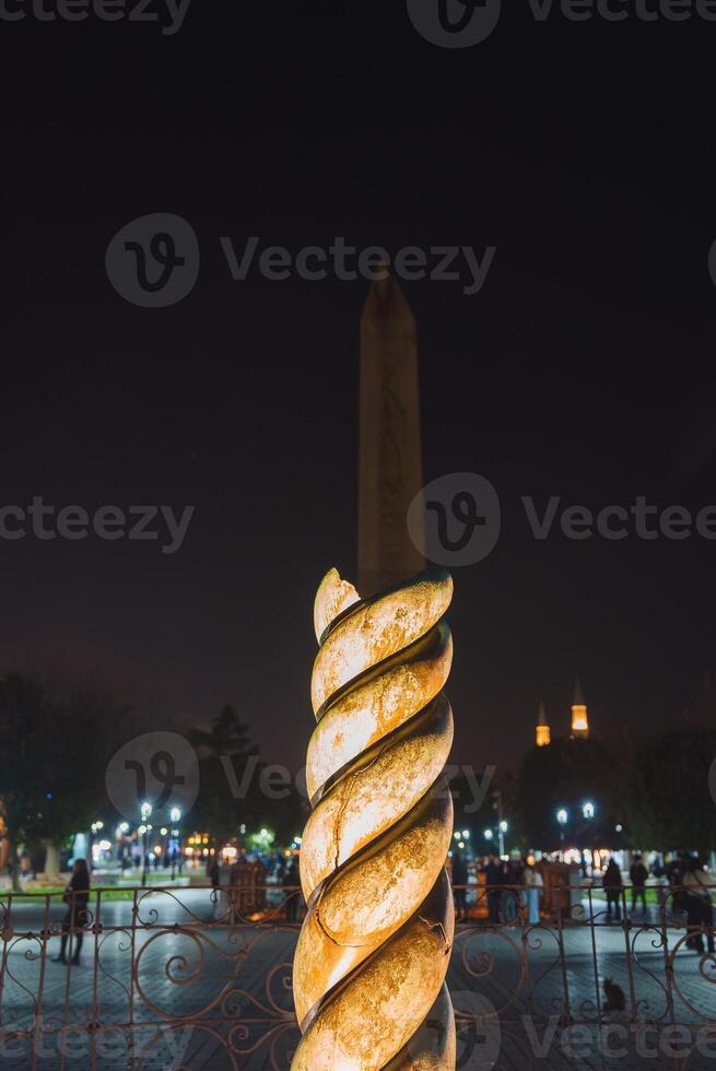 Serpent Column and Obelisk of Theodosius at Night in Istanbul Square photo