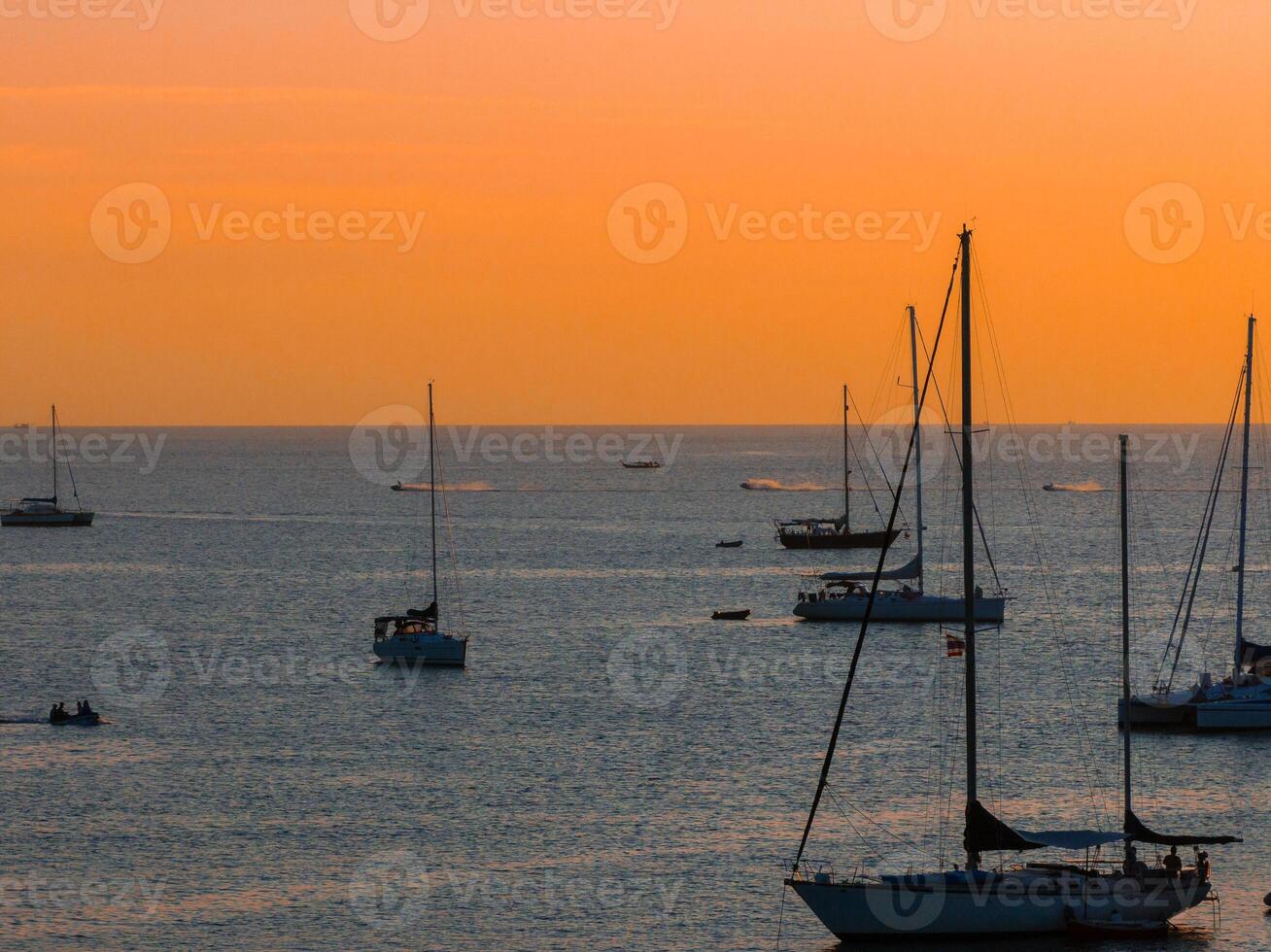 Serene Sunset Over Naiharn Beach with Anchored Sailboats photo