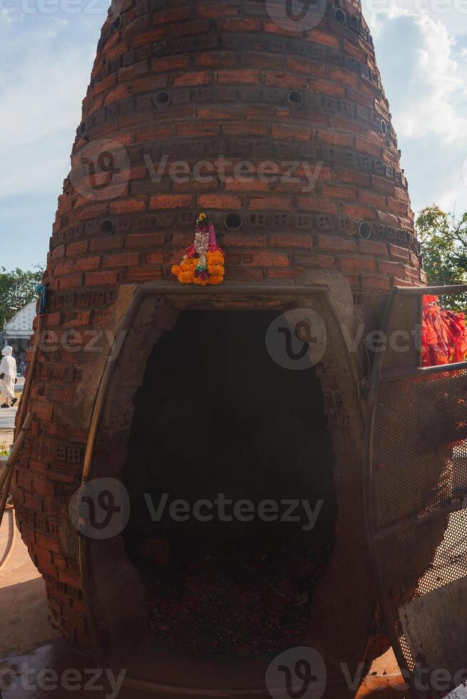 Conical Brick Kiln with Religious Statue in Outdoor Setting, Thailand photo