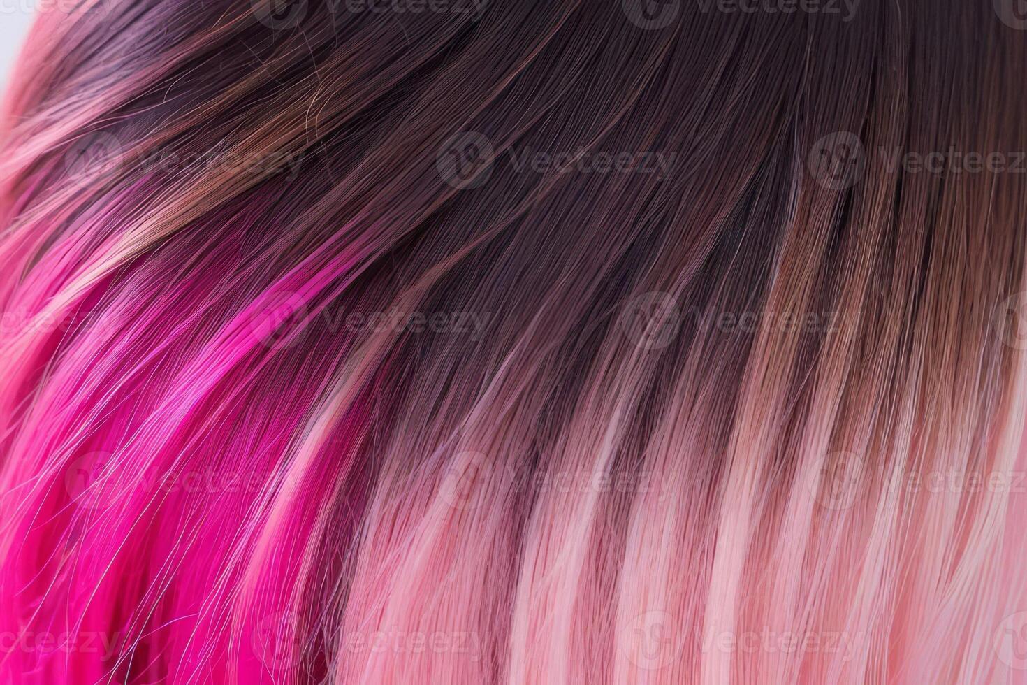 This close-up photo accentuates the vibrant allure of pink hair in an ombre design, revealing a harmonious fusion of colors
