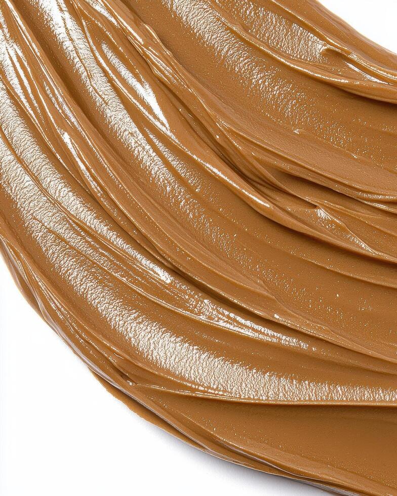 Close up of creamy brown spread, swirls and texture photo
