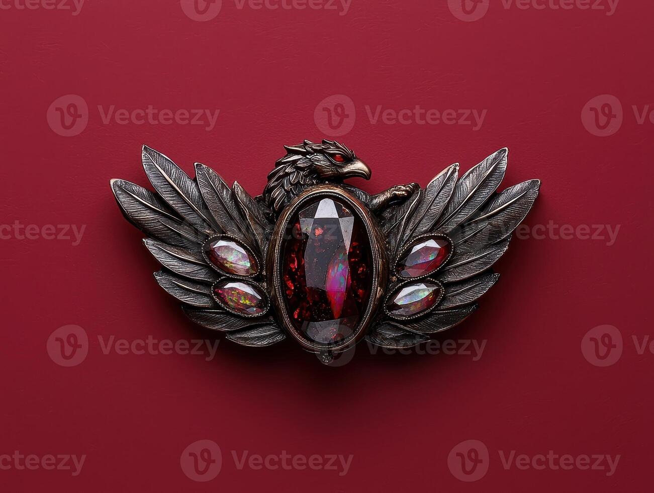 Ornate winged creature brooch with gemstone accents photo