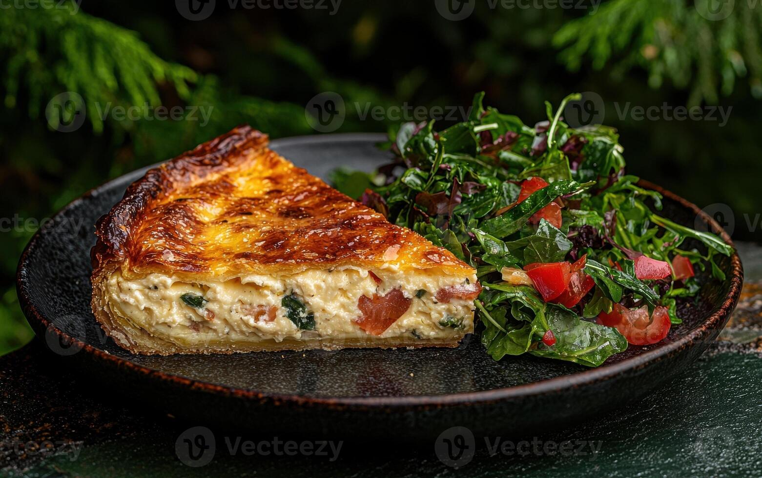 A slice of quiche with a side salad photo