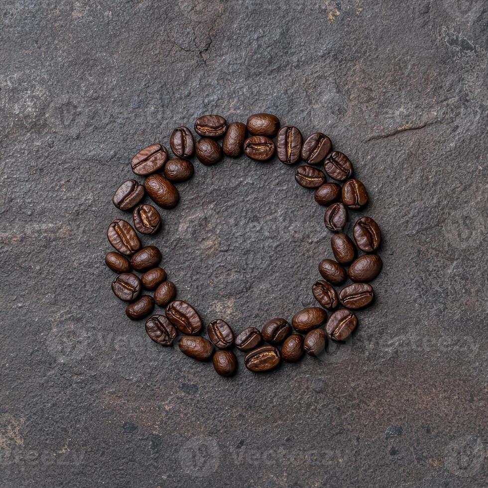 Coffee beans arranged in a circle on a dark background photo