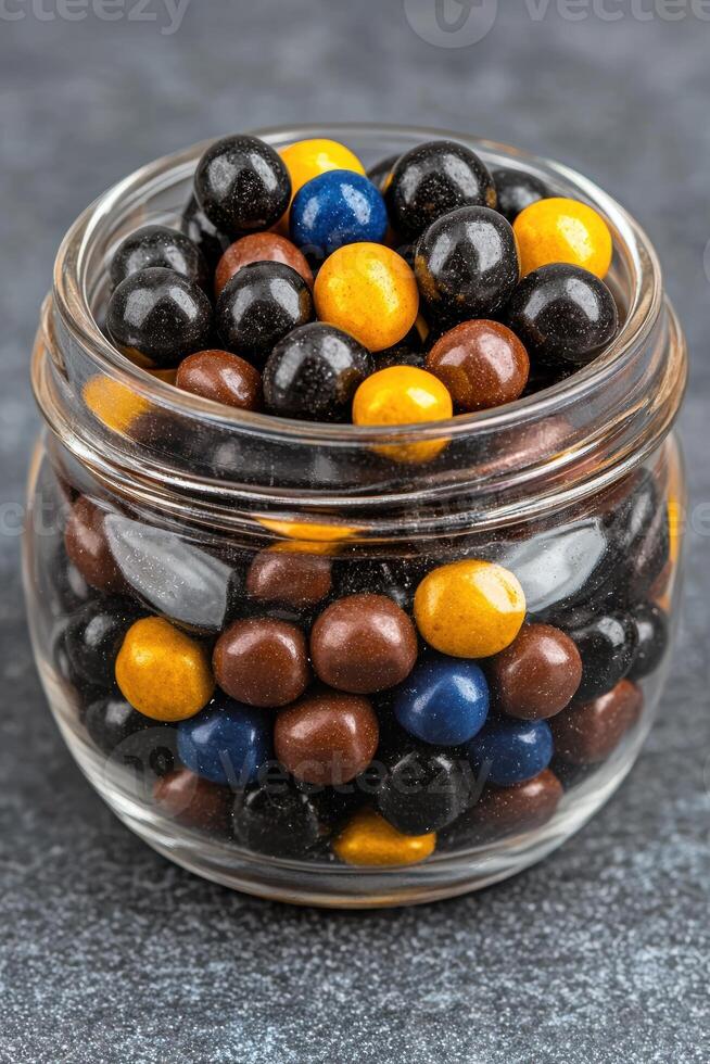 Colorful candy balls in a glass jar photo