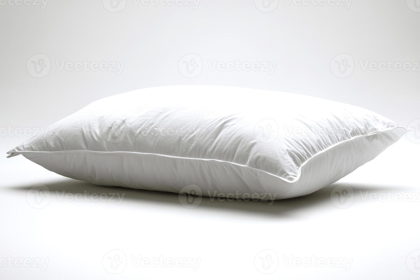 Comfortable white pillow resting on white background promoting relaxation and sleep photo