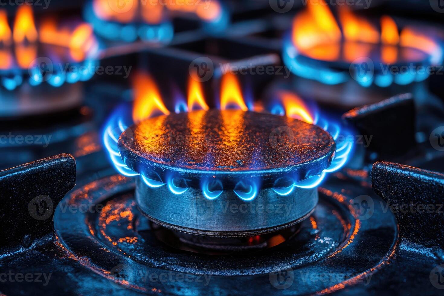 Gas burner showing blue flames burning on a stove top photo