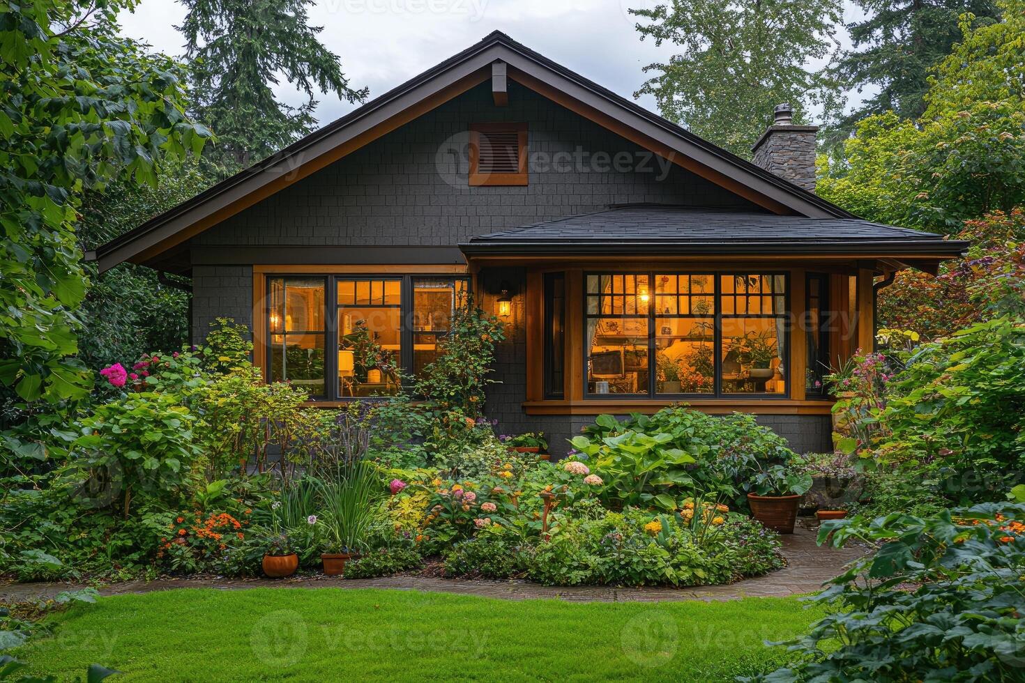 Craftsman bungalow house with illuminated interior and lush garden at dusk photo