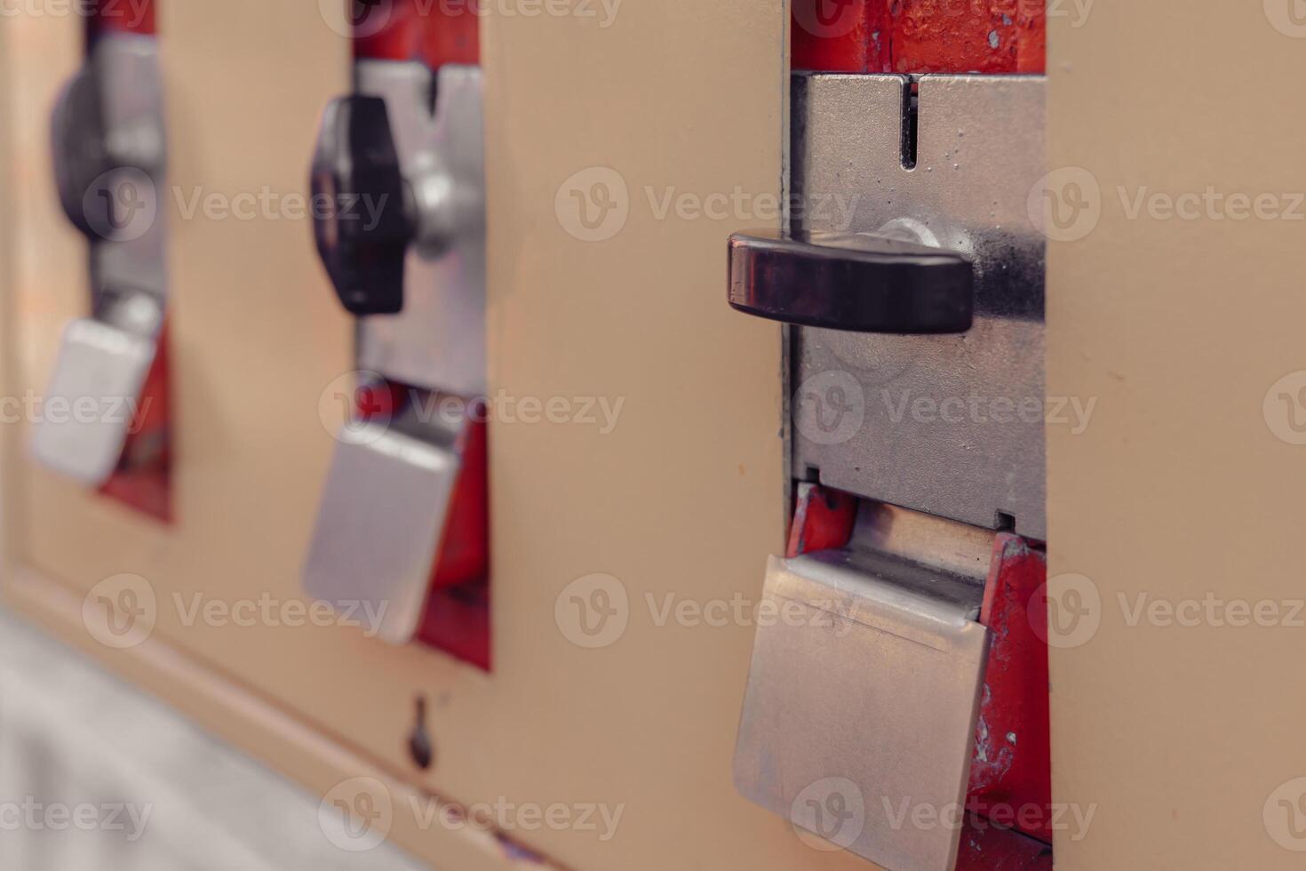 Vintage vending machine with classic coin slots and levers in a nostalgic setting photo