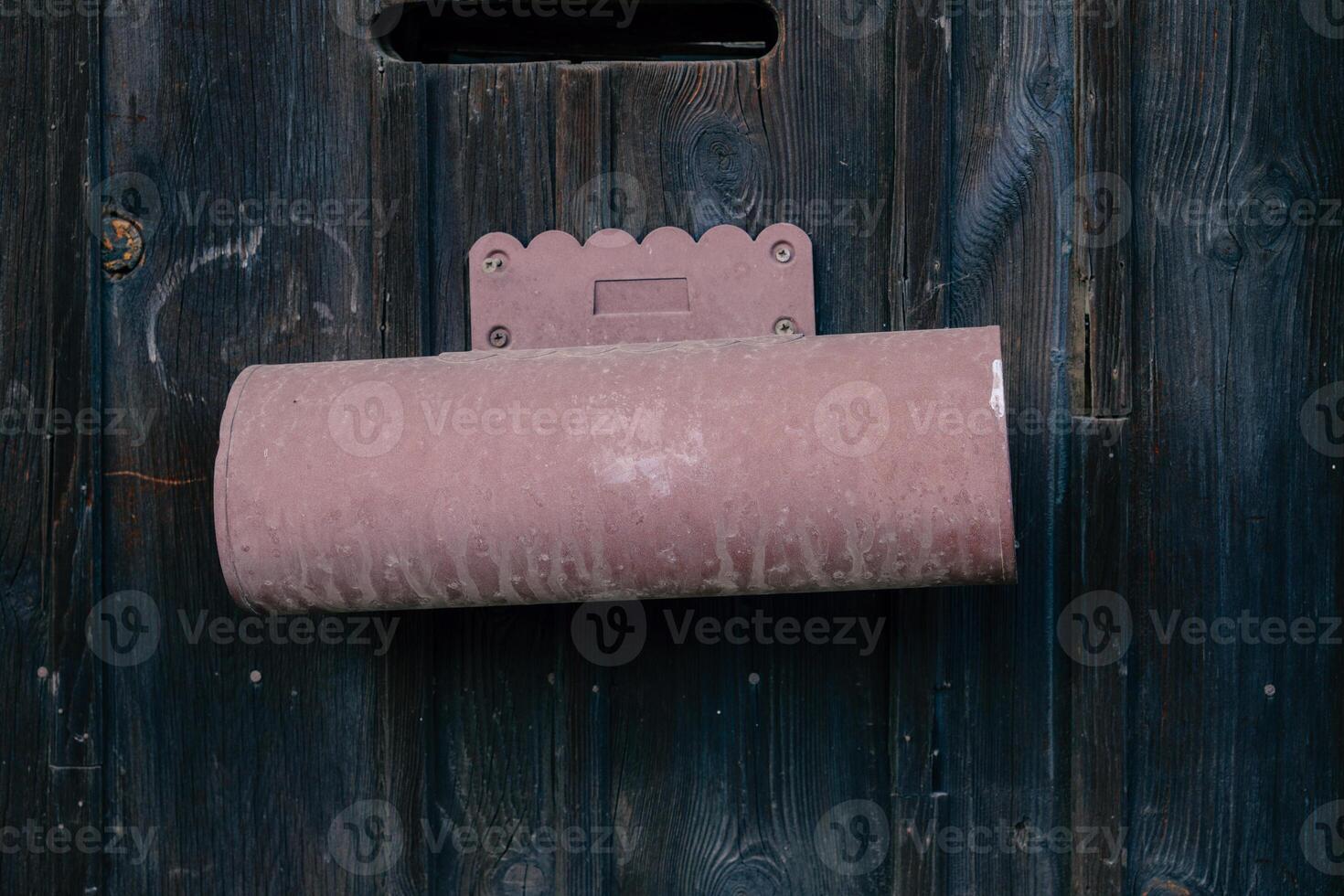 Rustic mail holder mounted on a dark wooden wall, enhancing home organization and aesthetic appeal in a quiet setting photo