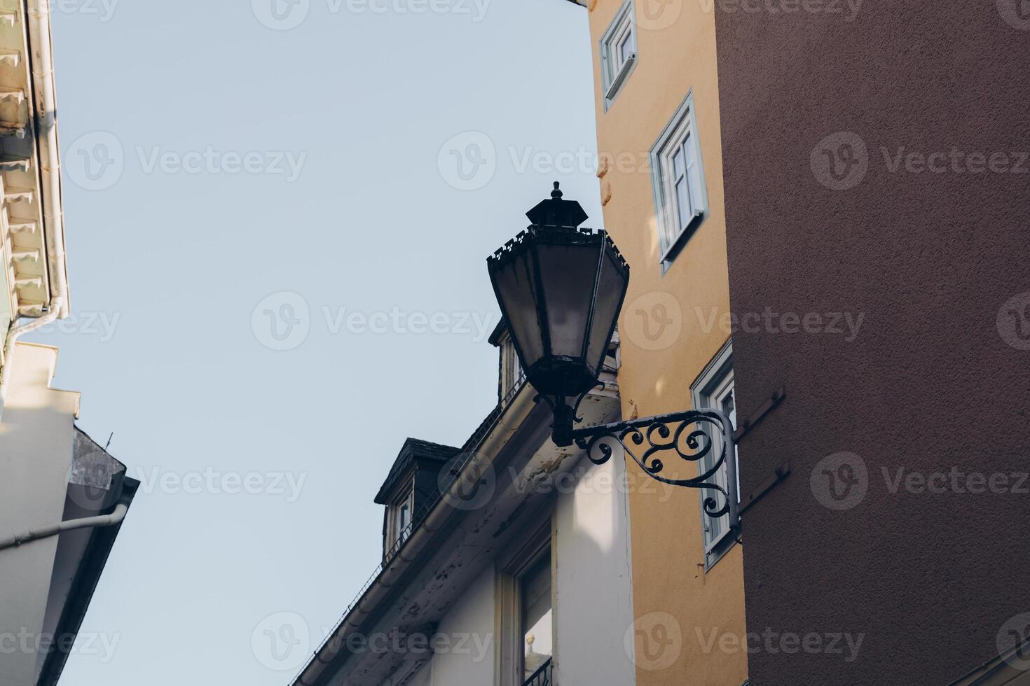 Historical street lamp stands elegantly between colorful buildings in a charming old town photo