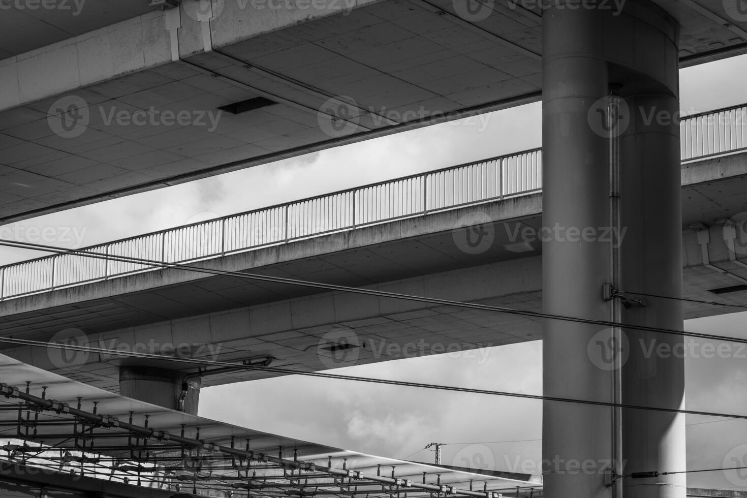 Urban overpass architecture showcases concrete structures under a cloudy sky photo