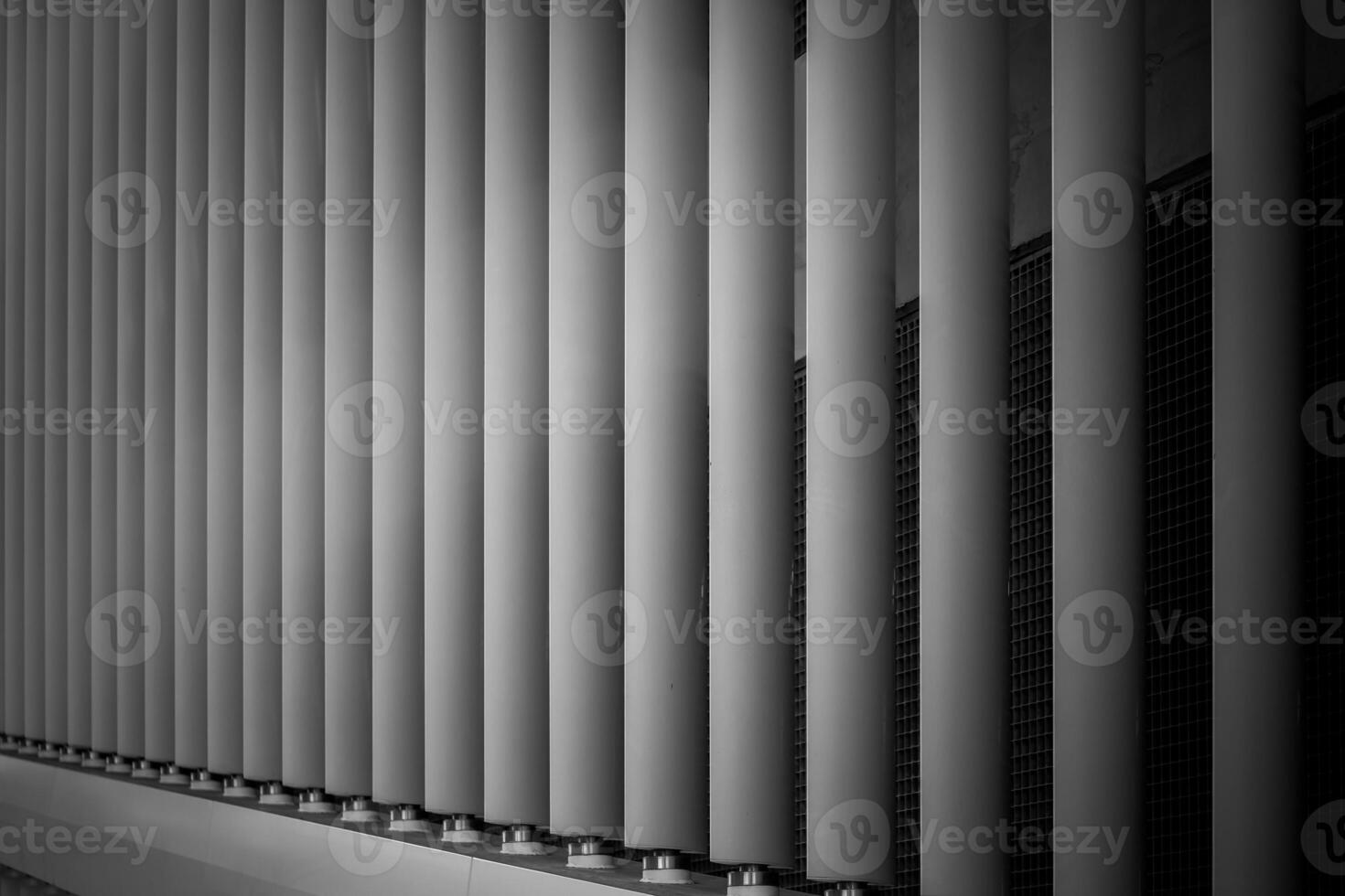 Shadows and lines created by architectural elements in a modern building during the daytime photo