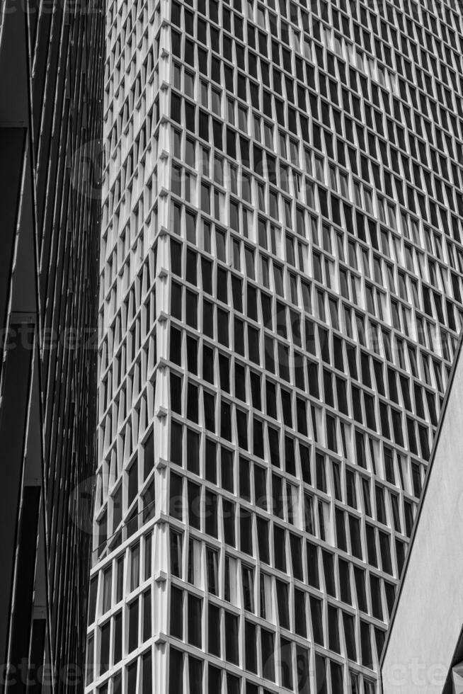 Modern architectural design featuring a grid pattern on a skyscraper in an urban environment captured during daylight photo