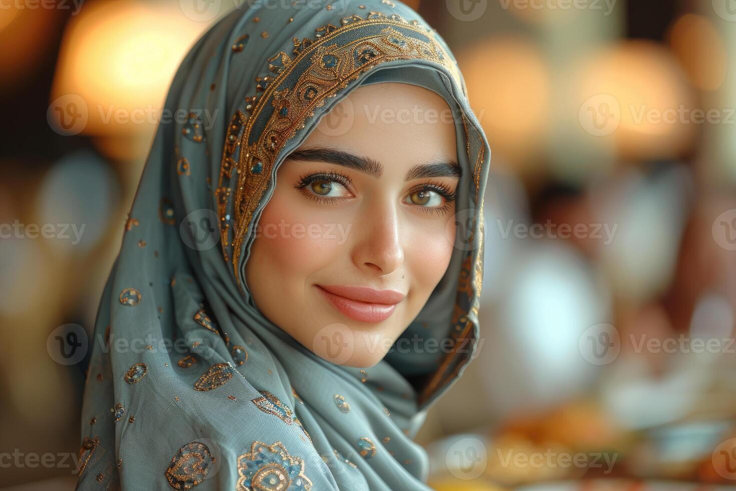 A woman wearing a headscarf and looking at the camera photo