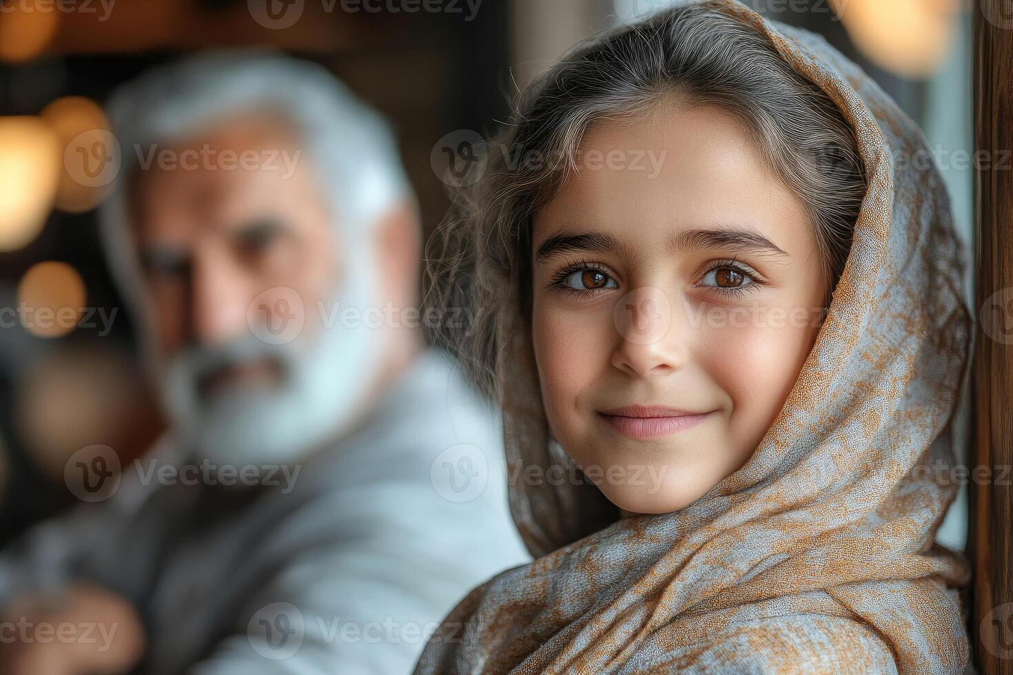 A young girl wearing a scarf and an older man photo