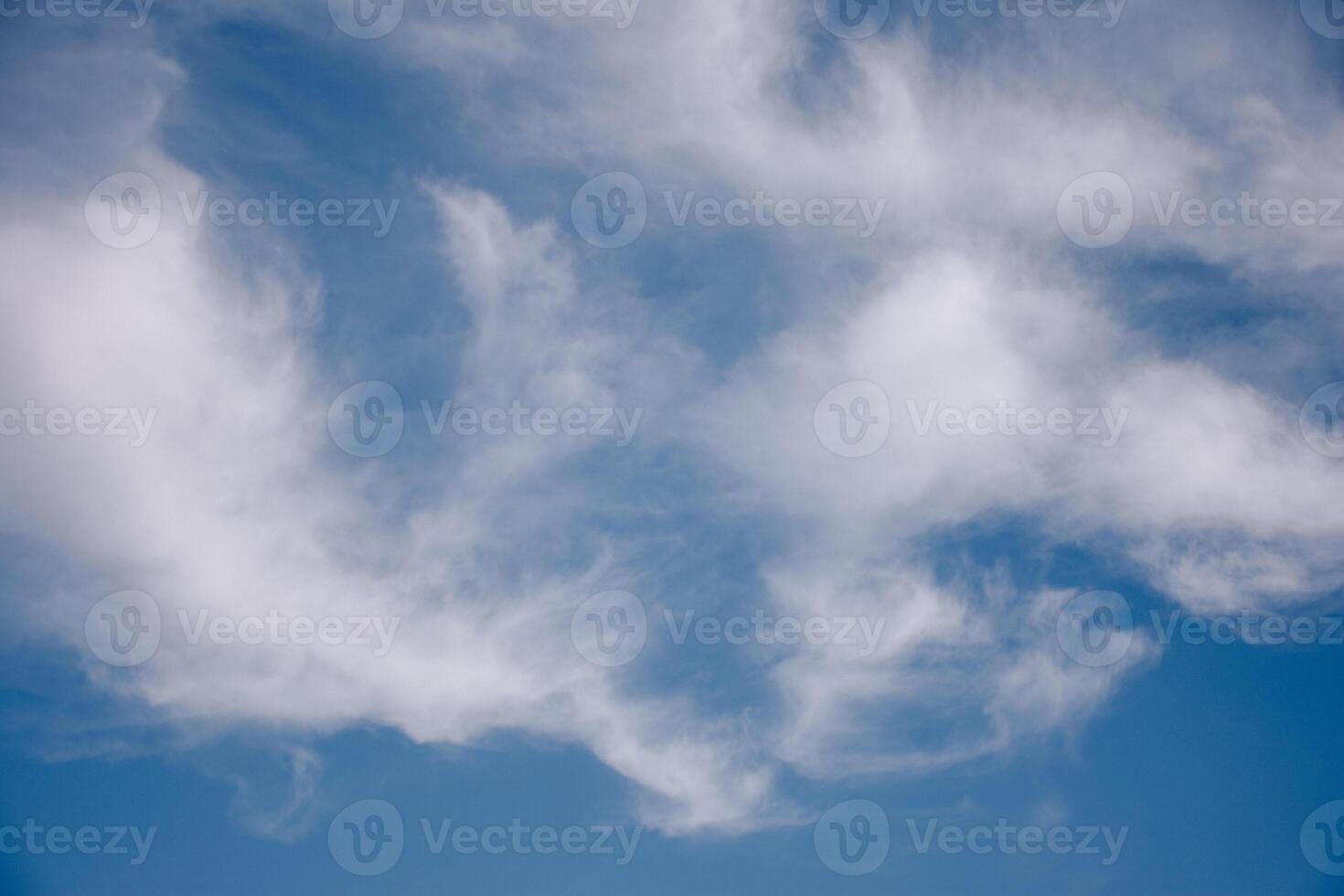 various shapes of clouds on different levels of blue photo