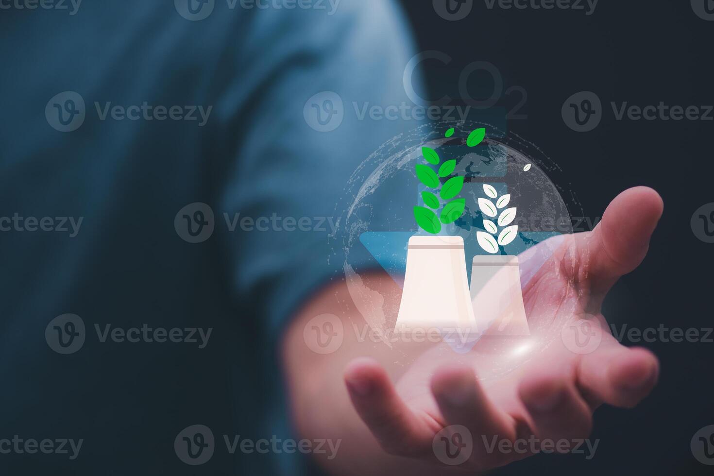 man holding a glass vase with plants and a plant in it photo