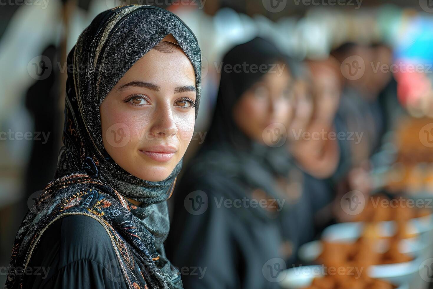 A woman in a hijab is standing in front of a line of people photo
